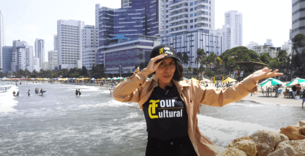 Roxeus enjoying the beach in Bocagrande, Cartagena, with modern skyscrapers in the background.