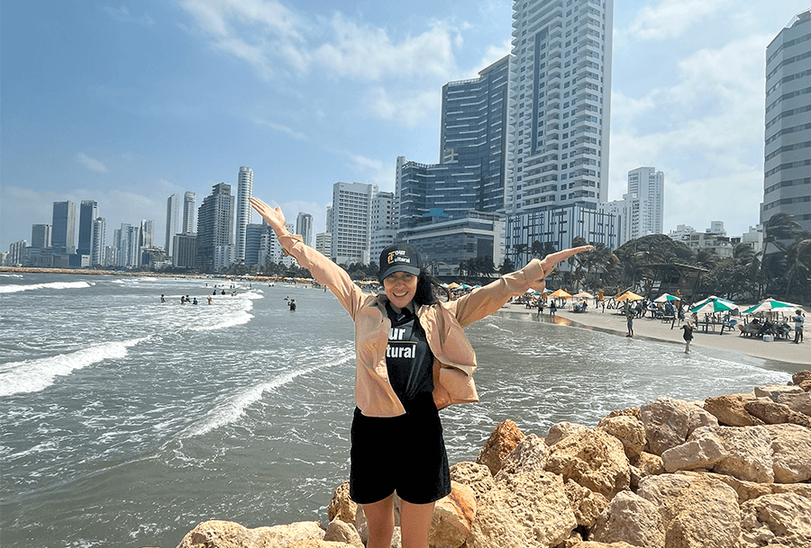 Roxeus enjoying the view in Bocagrande, Cartagena, Colombia, with skyscrapers and beach in the background.