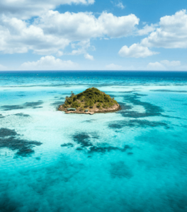 Aerial view of a tropical island surrounded by clear turquoise waters